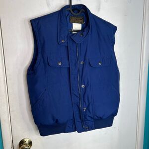 This is a vintage Eddie Bauer women's goose down-filled vest in blue 80’s strang